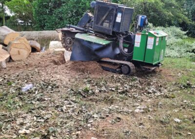 Tree chipper Tree surgeon Arbor Works Middlesbrough Stump Grinder amidst wood debris.